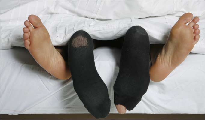 Paires de chaussettes dans le lit